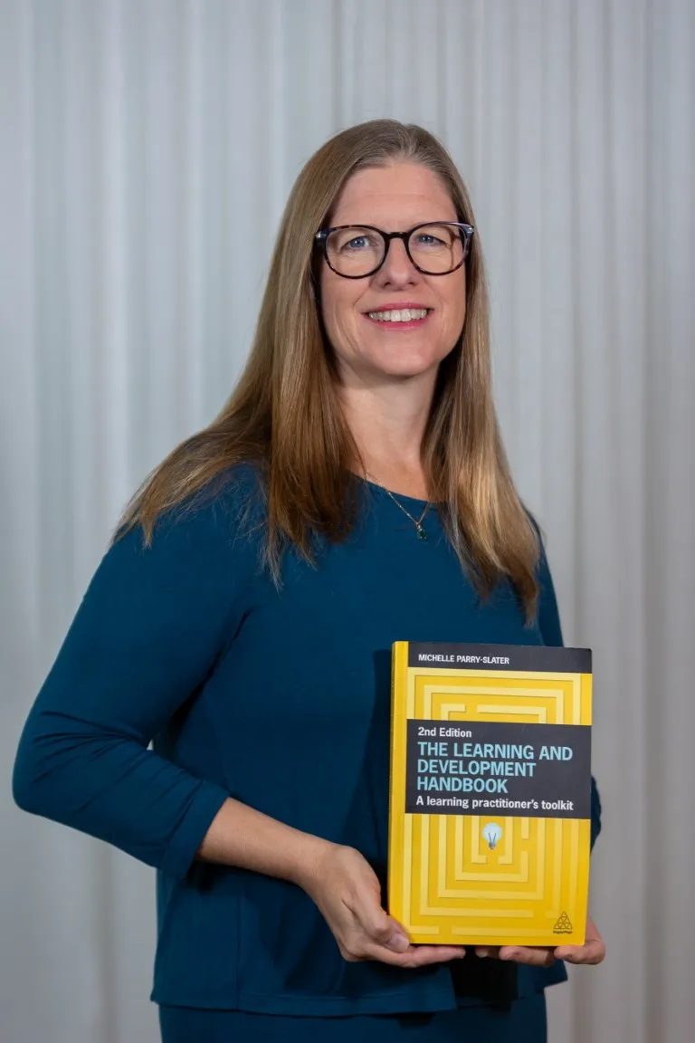 Michelle Parry-Slater holding her book